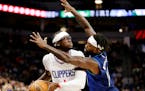 Clippers guard Reggie Jackson is guarded closely by Timberwolves guard Patrick Beverley during the first half