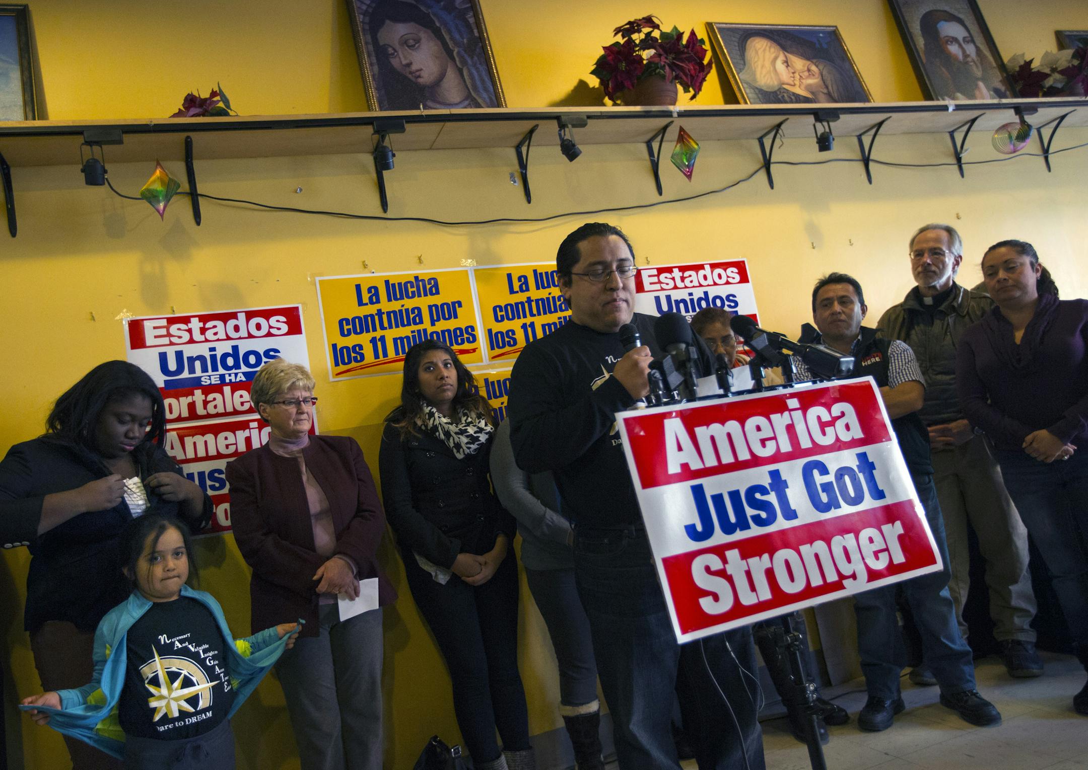 Community leaders and Immigrant families gathered Friday afternoon at theMercado Central in Minneapolis to share their reaction to the historic announcement by President Obama. Here, Daniel Deltoro (at podium), who has been working undocumented in Minnesota for 24 years said, "After today my family doesn't have to be afraid anymore, and I can go to my job without having to worry about weather or not I will be able to come home to my family." Deltoro's 5-year-old daughter Miranda (bottom left) wa