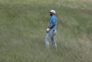 Dustin Johnson hits from some tall fescue on the 12th hole during a practice round for the U.S. Open golf tournament Wednesday, June 14, 2017, at Erin