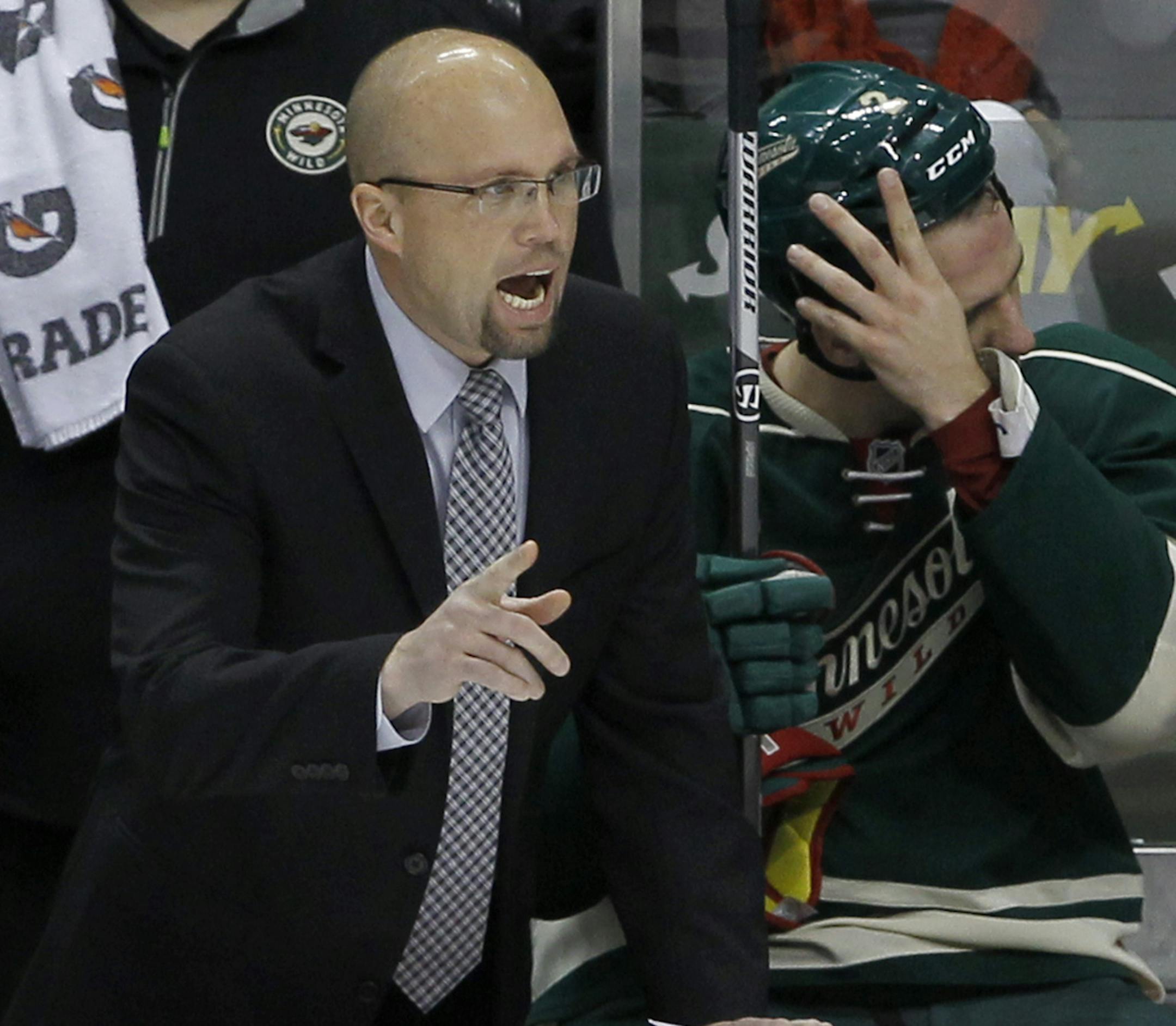 Minnesota Wild head coach Mike Yeo calls out to his players during the third period of an NHL hockey game against the Washington Capitals in St. Paul, Minn., Saturday, Jan. 4, 2014. The Wild won 5-3. (AP Photo/Ann Heisenfelt)