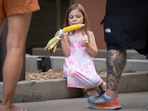 Estelle Alexander enjoys some sweet corn while at the Taste of Minnesota Sunday.