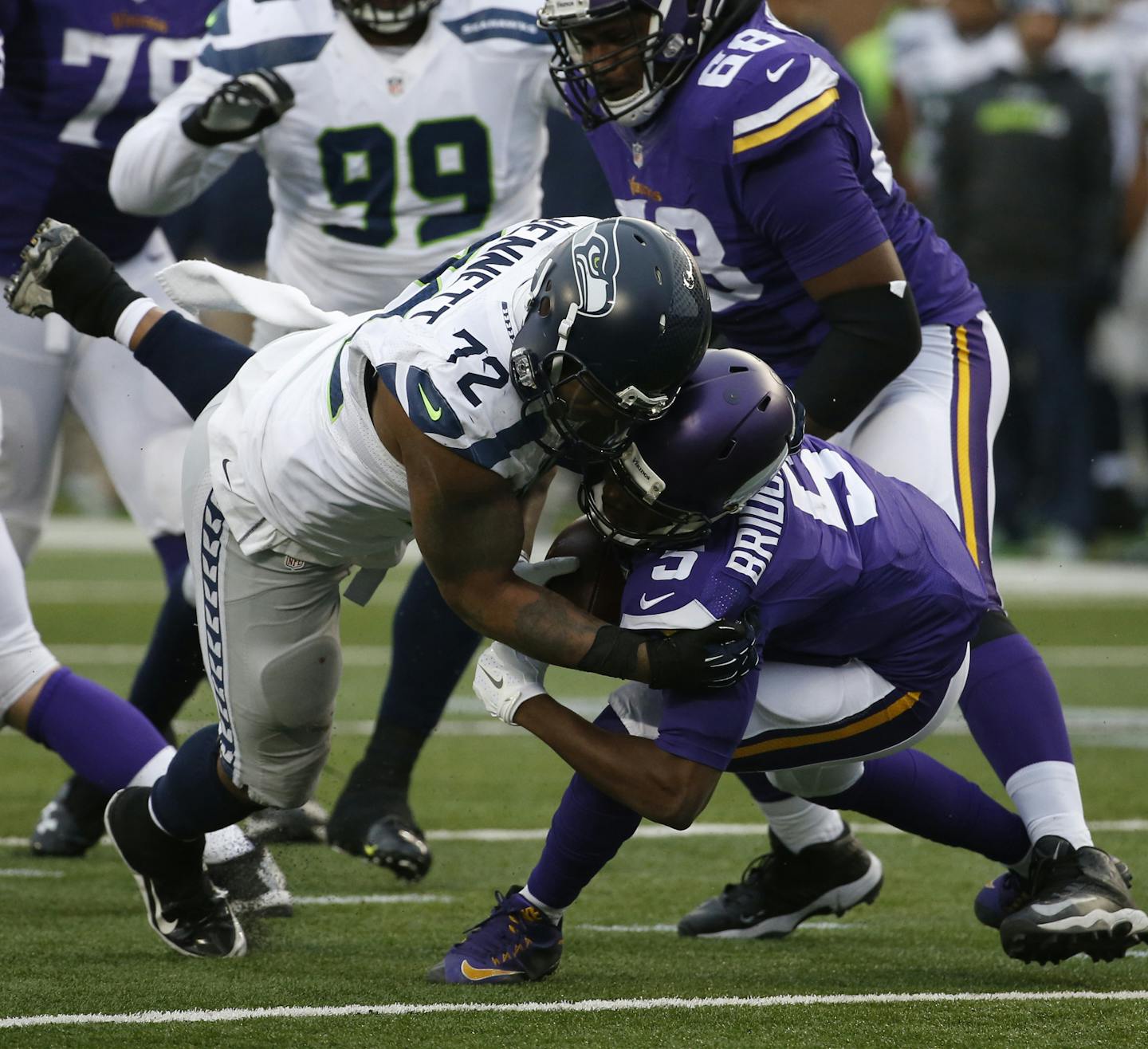 Seattle Seahawks defensive end Michael Bennett (72) sacks Minnesota Vikings quarterback Teddy Bridgewater (5) in the second half of an NFL football game Sunday, Dec. 6, 2015 in Minneapolis. Seattle won 38-7. (AP Photo/Ann Heisenfelt)