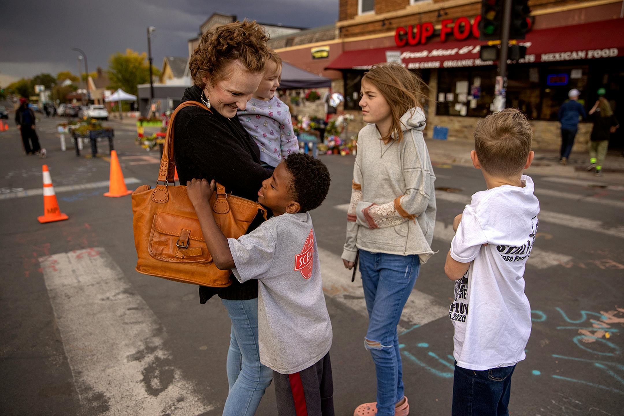 Kate Lundquist held onto Verabeth, 2, as the family made a visit to the the George Floyd memorial including from left, Maki, 8, Charlotte, 11, and Ridge, 9, Wednesday, September 30, 2020 in Minneapolis, MN.
