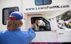 Republican U.S. Senate candidate Jason Lewis fist-bumped and shook hands with protesters from his RV during a "Liberate Minnesota" protest in St. Paul
