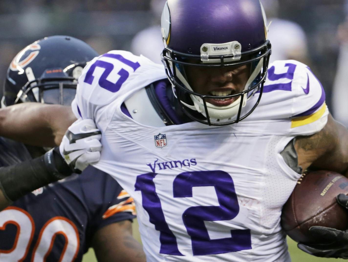 Minnesota Vikings receiver Charles Johnson (12) tries to avoid getting tackled by Chicago Bears cornerback Demontre Hurst (30) during the second half of an NFL football game Sunday, Nov. 16, 2014 in Chicago. The Bears won 21-13. (AP Photo/Charles Rex Arbogast)