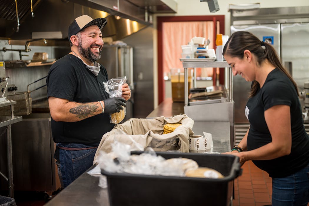 Chef Gustavo Romero in the kitchen of Nixta in northeast Minneapolis, with wife and co-owner Kate Romero.