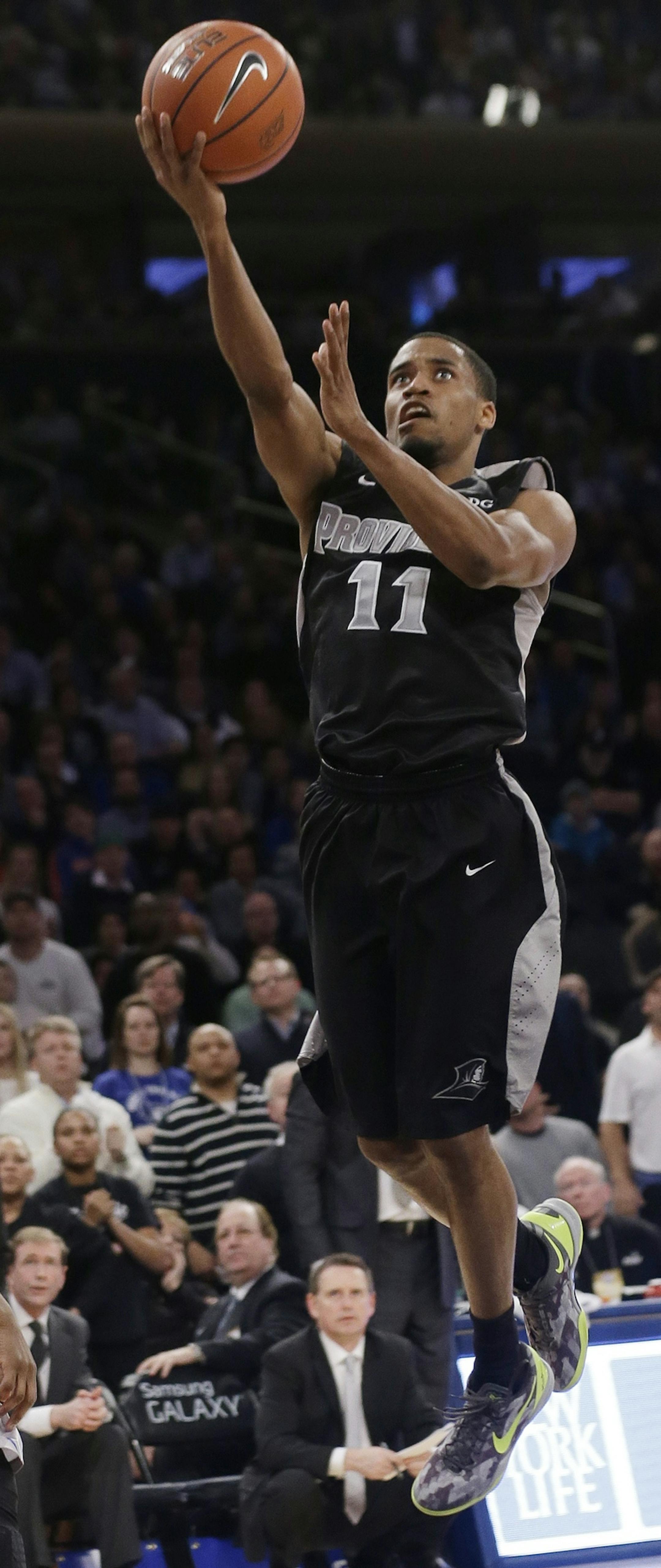 Providence's Bryce Cotton (11) drives past Creighton's Jahenns Manigat (12) during the second half of an NCAA college basketball game in the finals of the Big East Conference tournament Saturday, March 15, 2014, at Madison Square Garden in New York. Providence won the game 65-58. (AP Photo/Frank Franklin II)