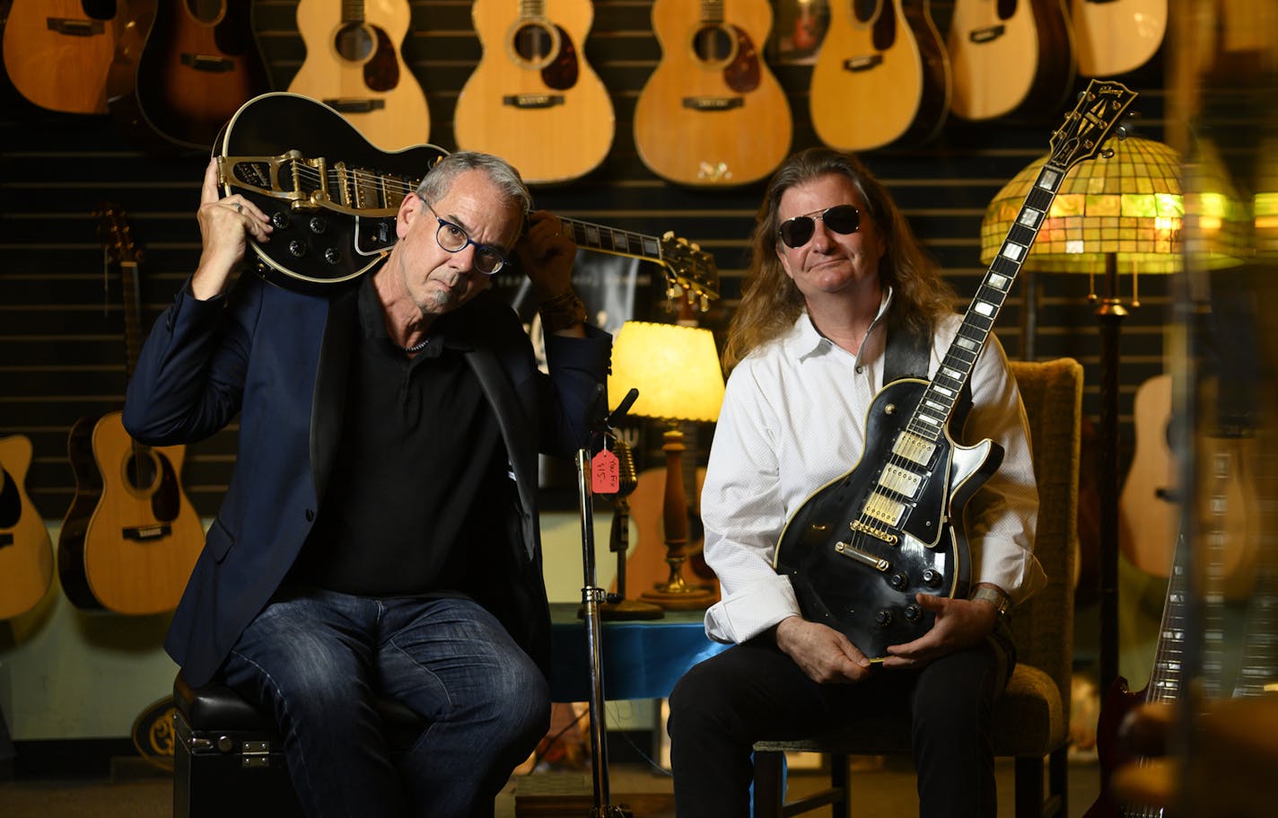 Willie's American Guitars owner Nate Westgor and Paul "Bleem" Claesgens at Westgor's shop in St. Paul. Westgor held a reissued copy of a 1958 Gibson Les Paul Custom guitar. Claesgens returned Jimmy Page's missing guitar and got this 1959 Gibson Les Paul Custom in a trade.