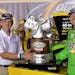 Kyle Busch, right, accepts the trophy from Advanced Auto Parts President Joe Sherman following his victory in the NASCAR Sprint Cup series auto race a
