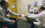 A patient received a prescription from his doctor as he combats chronic pain.