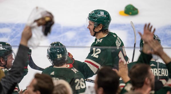 Fans threw hats on the ice as Minnesota Wild left wing Matt Boldy (12) celebrates his third period goal Sunday ,March,19,2023 in St.Paul, Minn.] JERRY