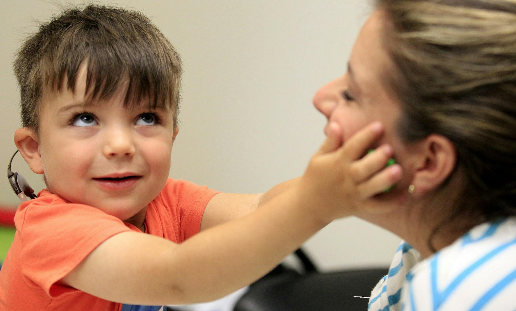 Three-year-old Auguste Majkowski listens for a series of tones as he participates in the testing of his new auditory brain stem implant device with his mother Sophie Gareau and audiologists at the USC Center for Childhood Communication on June 13, 2014 in Los Angeles. Auguste was diagnosed as being profoundly deaf when he was a year and a half old, and the test was part of his participation in a National Institutes of Health clinical study. (Brian van der Brug/Los Angeles Times/MCT)