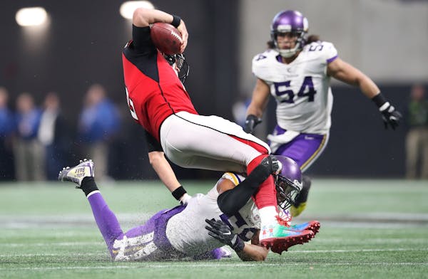 Minnesota Vikings outside linebacker Anthony Barr (55) tackled Atlanta Falcons quarterback Matt Ryan (2) after he picked up two yards in the third qua