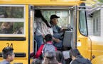 Don Brink picks up students on his route in Worthington, Minn. The town has seen an influx of undocumented children, but Brink does not support a plan