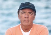James Patterson, on the edge of a body of water