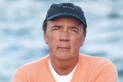 James Patterson, on the edge of a body of water