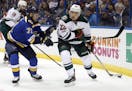 Minnesota Wild's Nino Niederreiter, of Switzerland, looks to pass as St. Louis Blues' Vladimir Sobotka, left, of the Czech Republic, defends during th