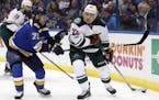 Minnesota Wild's Nino Niederreiter, of Switzerland, looks to pass as St. Louis Blues' Vladimir Sobotka, left, of the Czech Republic, defends during th