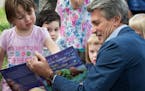 Minneapolis Foundation president and CEO R.T. Rybak read Good Night, Little Sea Otter to a group of kids at the Book It to the Parks event.