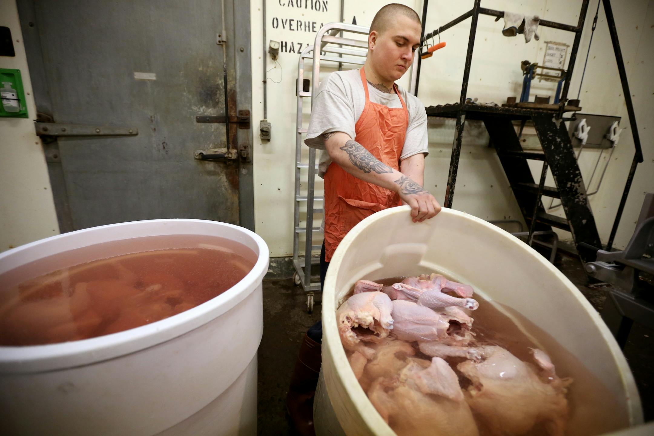 Zach Malich an inmate at the Northeast Regional Corrections Center poured water of chickens. Inmates at the Northeast Regional Corrections Center butcher chickens and pigs mostly to eat later in the week for lunch. A few lawmakers want to turn that loose program into a certification-granting curriculum with the idea that it will help the men get jobs and, more broadly, respond to a shortage of butchers.