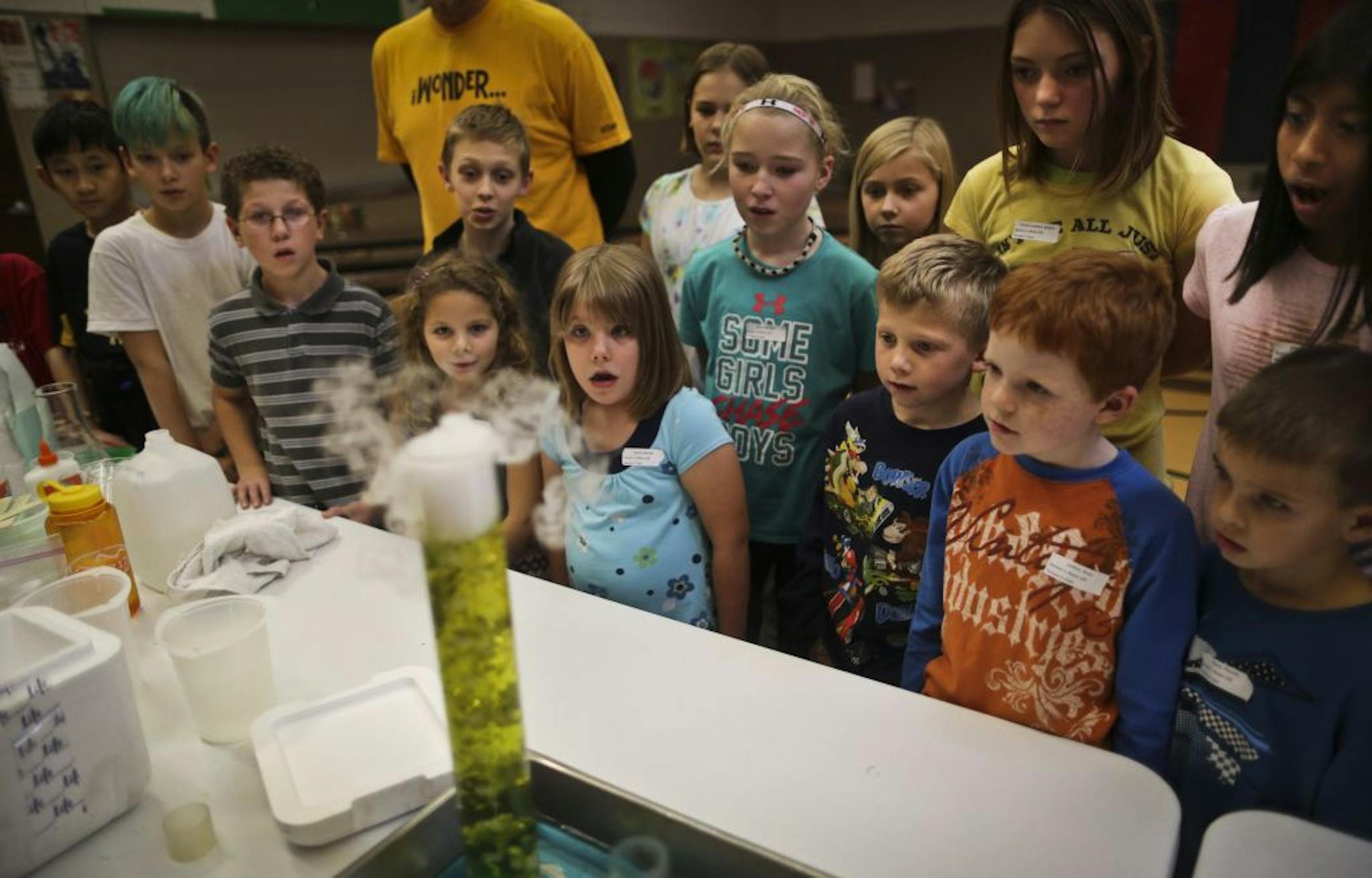 Children from East Union Elementary School watched a test tube change colors during an experiment making acid using dry ice. In Carver, Minn. on Tuesday, Nov. 20, 2012, staff from the Science Museum and Cargill made presentations to students on science, technology and engineering that included hands-on activities for students.