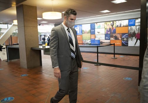 Former police officer Thomas Lane walks through security as he arrived for a hearing at the Hennepin County Government Center in Minneapolis on July 21, 2020.