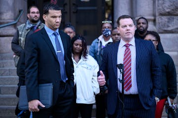 Attorneys Christopher Scott, left, and Jeff Storms spoke to the media during a news conference outside Minneapolis City Hall Tuesday, Nov. 9, 2021 in 