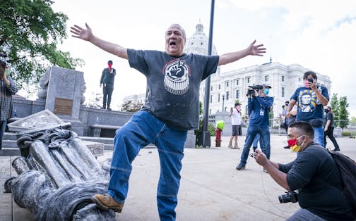 Mike Forcia, of the Black River Anishinabe, celebrated after the Christopher Columbus statue was toppled. ] LEILA NAVIDI • leila.navidi@startribune.com BACKGROUND INFORMATION: Activists pulled down the statue of Christopher Columbus in front of the Minnesota State Capitol in St. Paul on Wednesday, June 10, 2020.