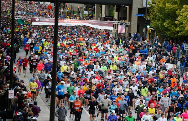 The 2014 Twin Cities Marathon begins on a clear, cold morning on Oct. 5, 2014.