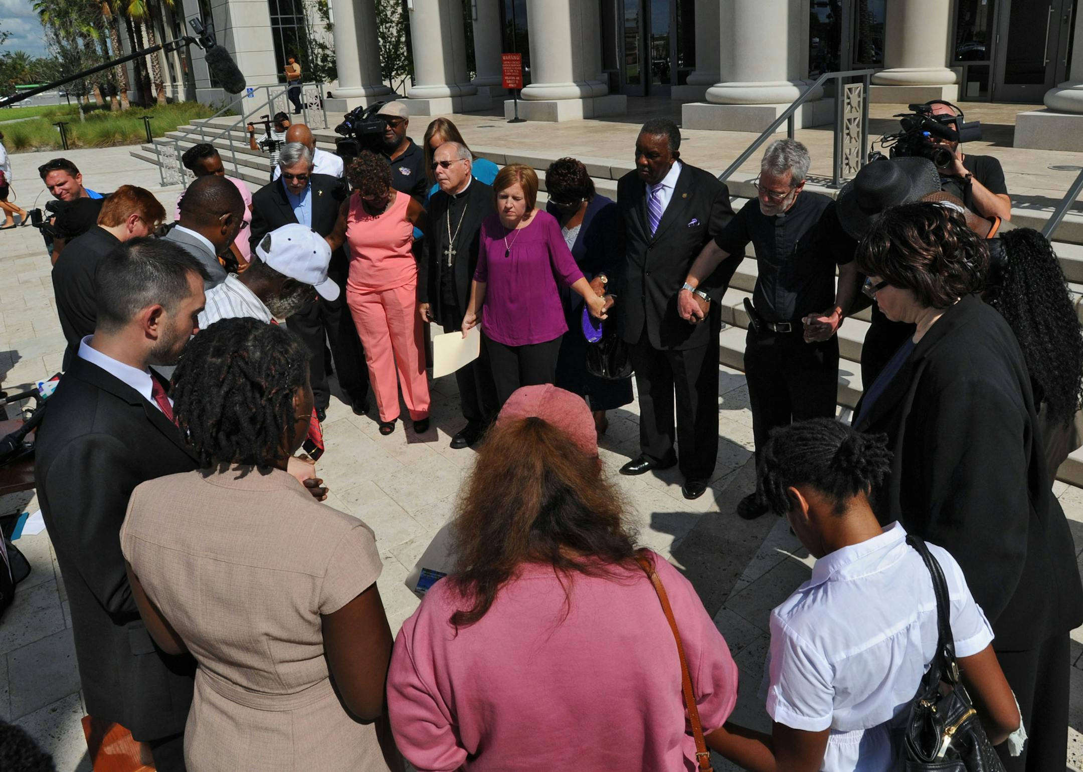 Representatives of a group of over 50 faith leaders from the Jacksonville, Fla. area hold a news conference in front of the Duval County Courthouse to call for the end of the death penalty, Wednesday Aug. 24, 2016. (Bob Mack/The Florida Times-Union via AP)