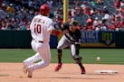 Los Angeles Angels' Gio Urshela, left, steals second as Minnesota Twins shortstop Carlos Correa can't reach the throw from home during the eighth inni