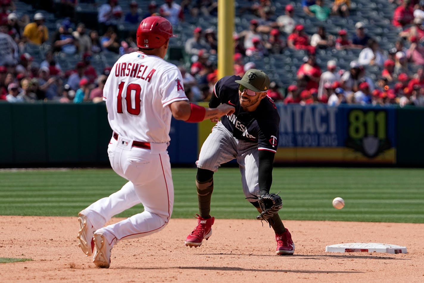 Los Angeles Angels' Gio Urshela, left, steals second as Minnesota Twins shortstop Carlos Correa can't reach the throw from home during the eighth inning of a baseball game Sunday, May 21, 2023, in Anaheim, Calif. Urshela advanced to third and catcher Ryan Jeffers was charged with a throwing error on the play. (AP Photo/Mark J. Terrill)