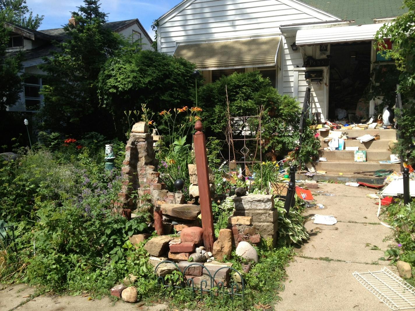 On Tuesday morning, the front garden that neighbors say Charles Nightingale spent so much time cultivating was littered with soggy mementos after a fatal fire.