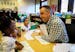 Kindergarten teacher David Boucher made kindergartener Cedrianna laugh as they read together during class at Folwell School, Performing Arts Magnet Sc