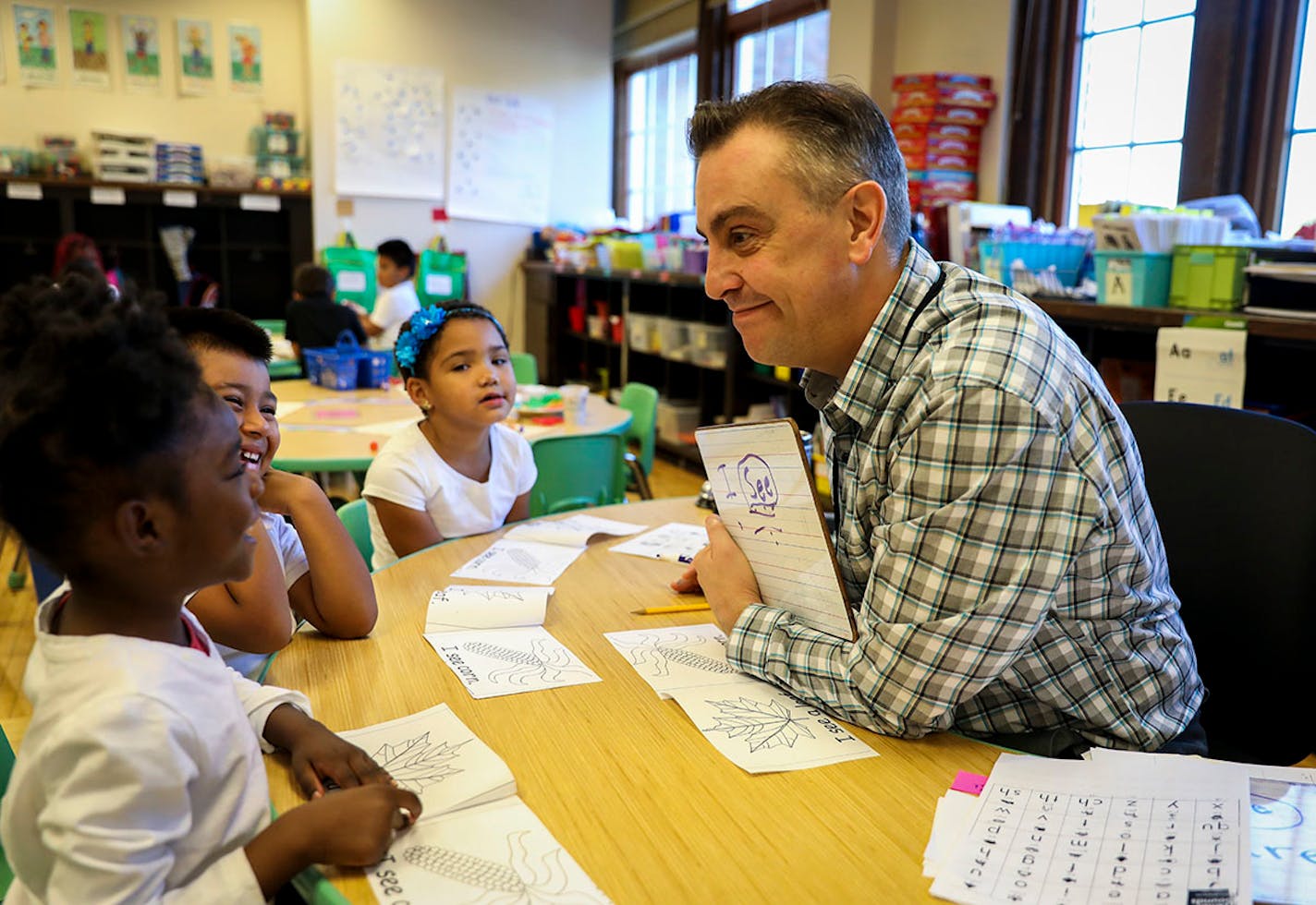 Kindergarten teacher David Boucher made kindergartener Cedrianna laugh as they read together during class at Folwell School, Performing Arts Magnet School on Tuesday, October 18, 2016, in Minneapolis, Minn.