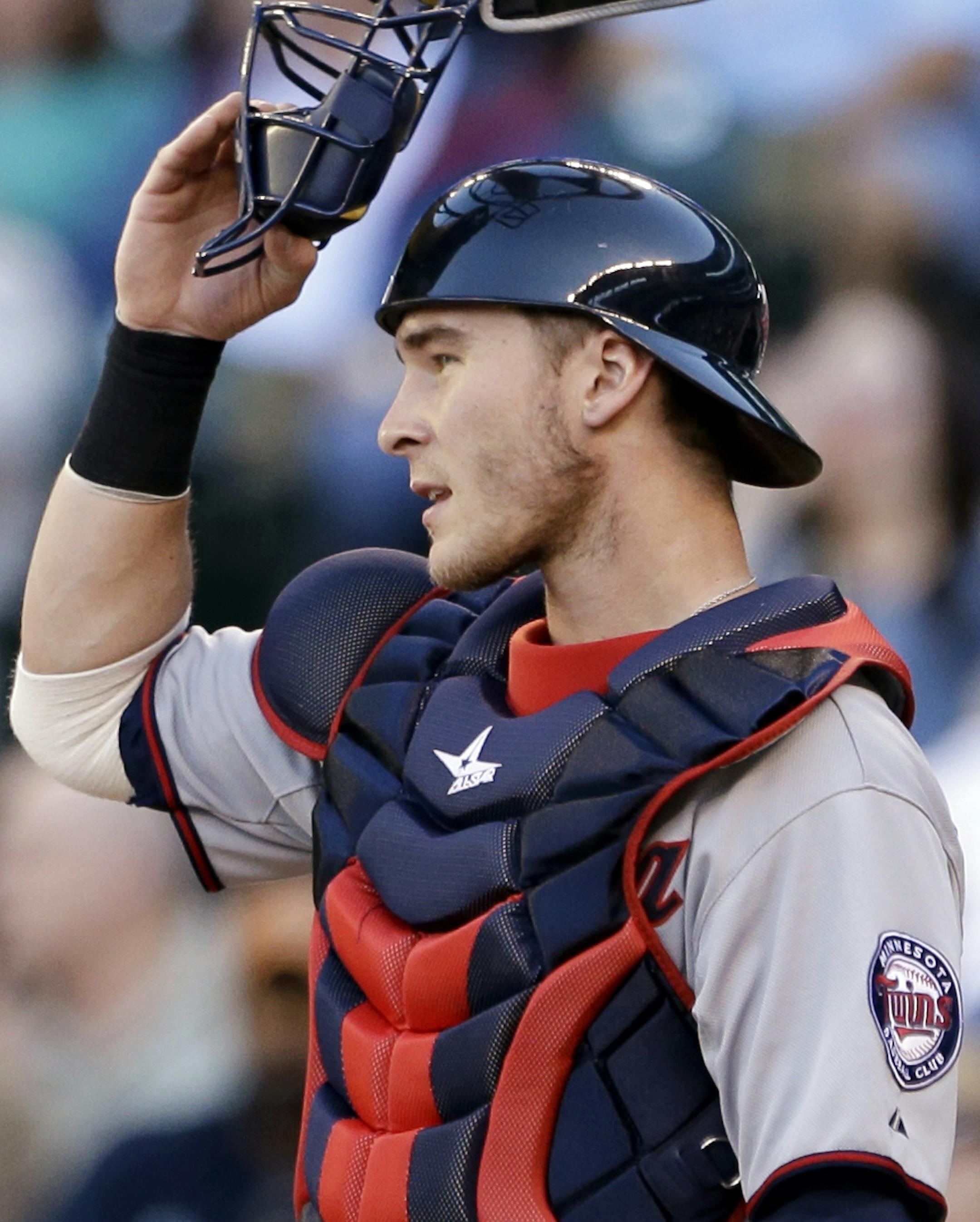 Minnesota Twins cacher Chris Herrmann pauses between Seattle Mariners batters in a baseball game Thursday, July 25, 2013, in Seattle. (AP Photo/Elaine Thompson) ORG XMIT: OTK