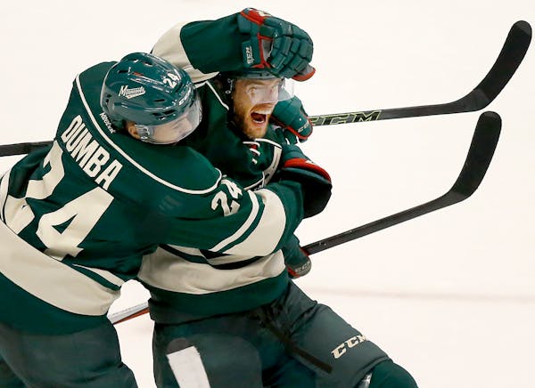 Jason Pominville (29) celebrated with Matt Dumba (24) after scoring goal in the second period.