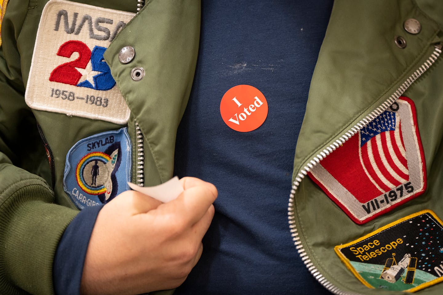 Bryce Maples puts on his "I voted" sticker after voting at Emerson Dual Language School on Election Day in Ward 7 in Minneapolis, Minn. on Tuesday, Nov. 7, 2023.