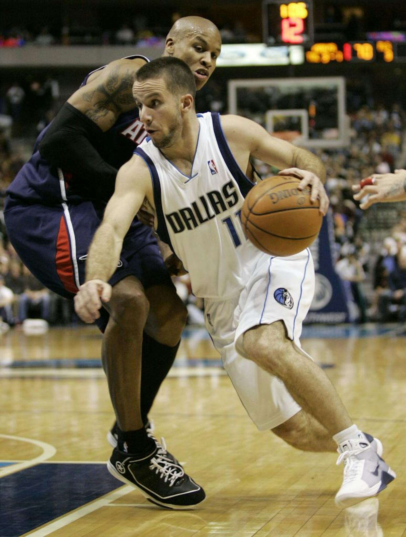 Dallas Mavericks guard Jose Juan Barea (11) of Puerto Rico and Atlanta Hawks forward Maurice Evans, left, during an NBA basketball game in Dallas, Saturday, Dec. 6, 2008.