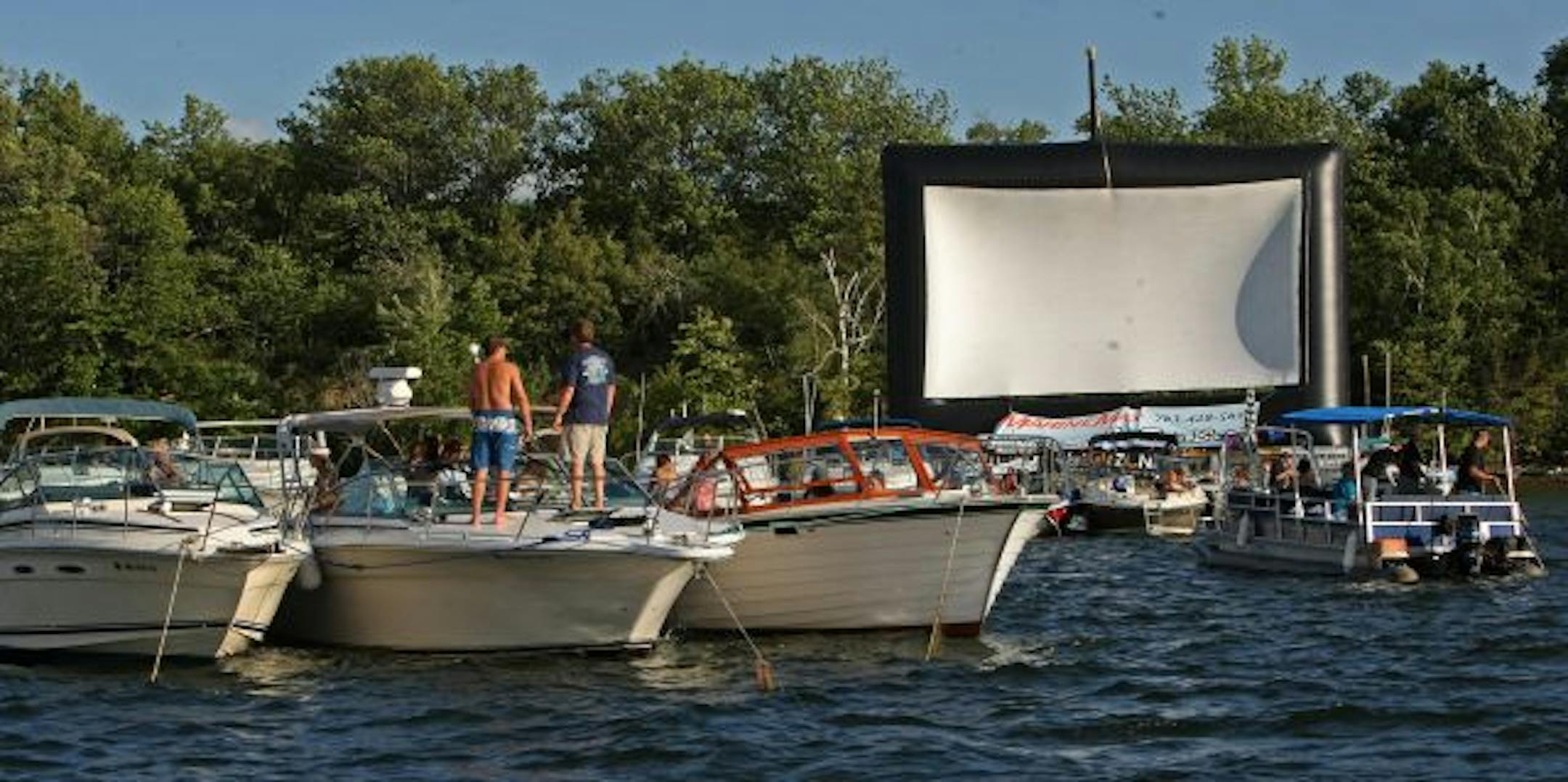 Boaters gathered Friday evening for a screening of "Top Gun" near Big Island at Lake Minnetonka. The second annual "boat-in" movie — think drive-in without the cars — was promoted as a family-friendly event and featured a 40-foot-wide screen mounted on a barge.