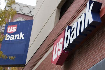 FILE - In this Oct. 20, 2009, file photo, signs on a US Bank branch in Omaha, Neb., are shown in Omaha, Neb. U.S. Bancorp reports quarterly earnings o