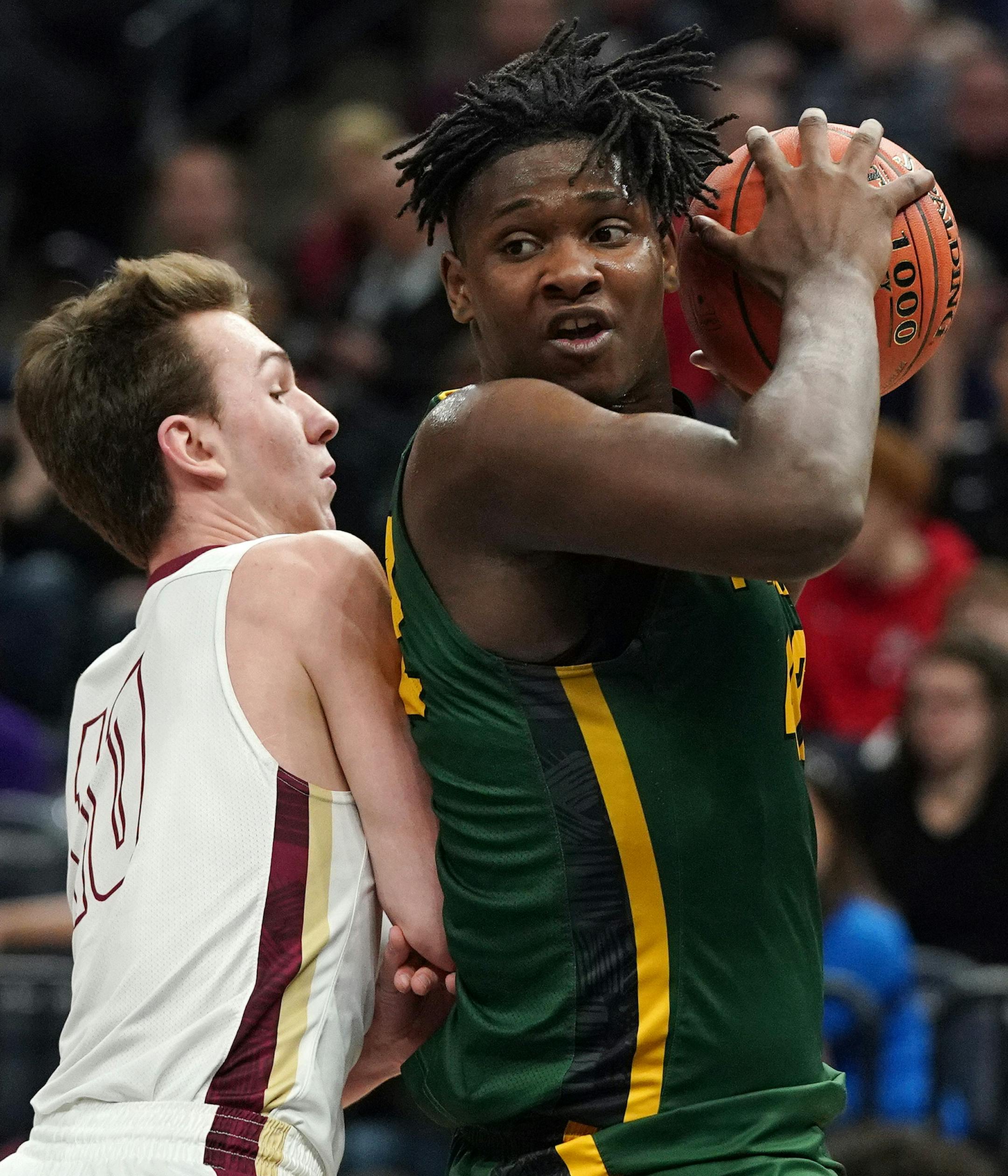 Park Center forward Dain Dainja (42) made a move around Maple Grove forward Sean Bergstrom (10) as he drove to the basket in the second half. ] ANTHONY SOUFFLE &#x2022; anthony.souffle@startribune.com Park Center High School played Maple Grove High School in a MSHSL boys' basketball quarterfinal game Wednesday, March 20, 2019 at the Target Center in Minneapolis.