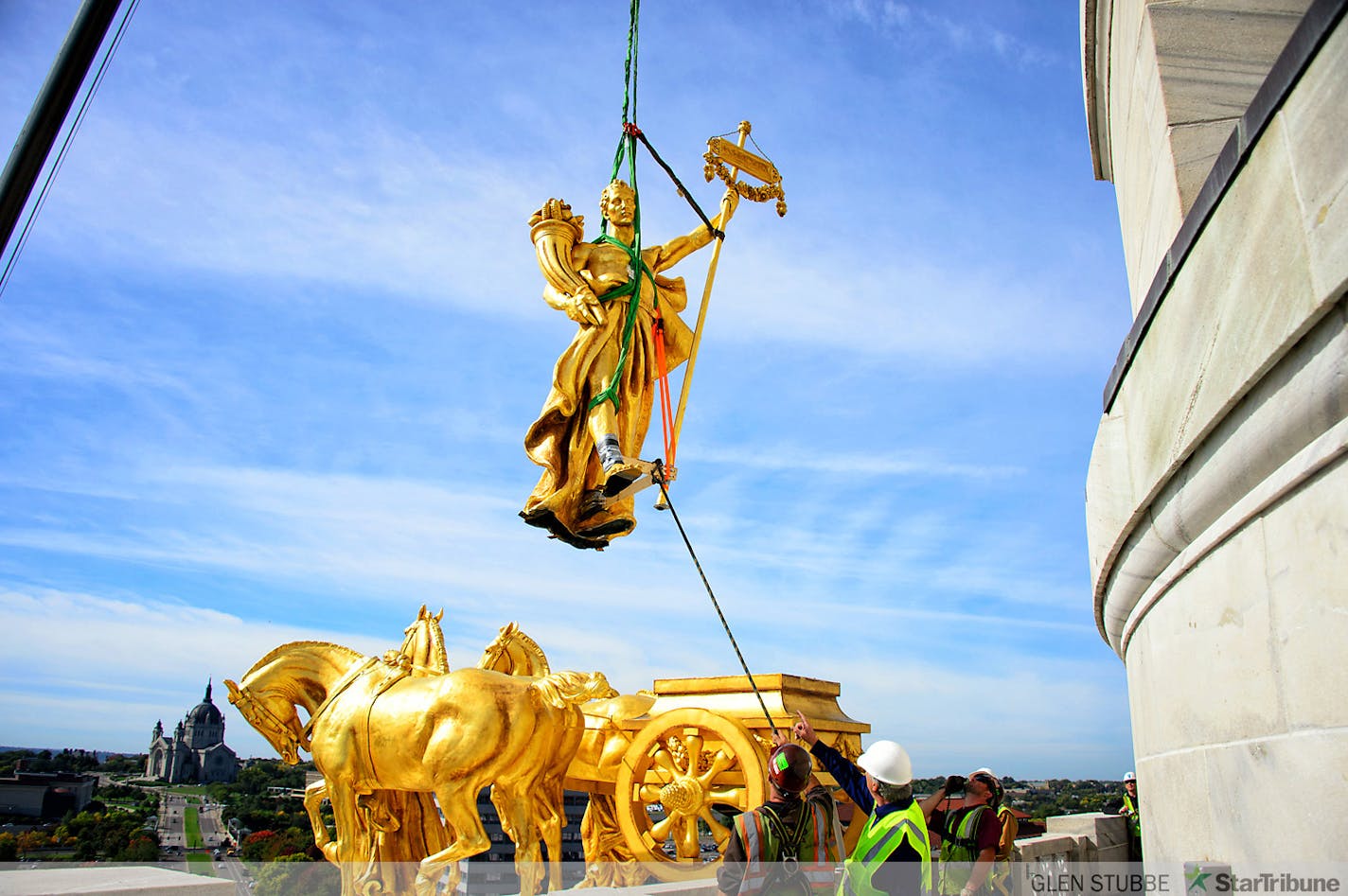 The charioteer figure who guides the golden horses on the Minnesota State Capitol Building's Quadriga statue were temporarily removed on Tuesday, September 23 to repair corrosion discovered at the statue's base. The repair is expected to take approximately three months when charioteer will return to the Quadriga.    ]   Tuesday, September  23, 2014   GLEN STUBBE * gstubbe@startribune.com