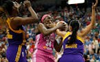 Lynx center Sylvia Fowles (34) protected the ball against Sparks center Jantel Lavender, left, and guard Ana Dabovic, right, during the second half of