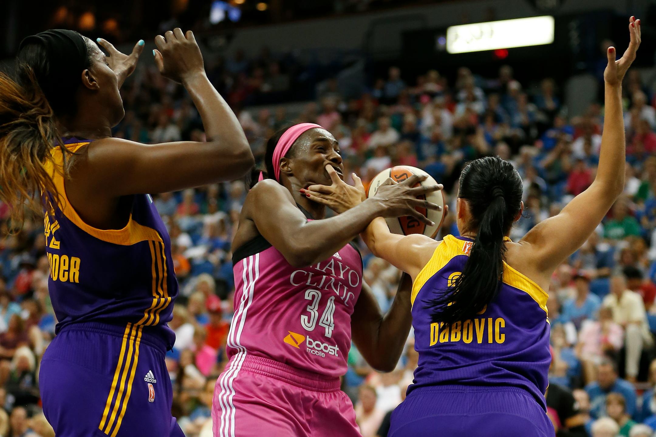 Lynx center Sylvia Fowles (34) protected the ball against Sparks center Jantel Lavender, left, and guard Ana Dabovic, right, during the second half of the Lynx's 72- 64 victory over the Sparks on Sunday.