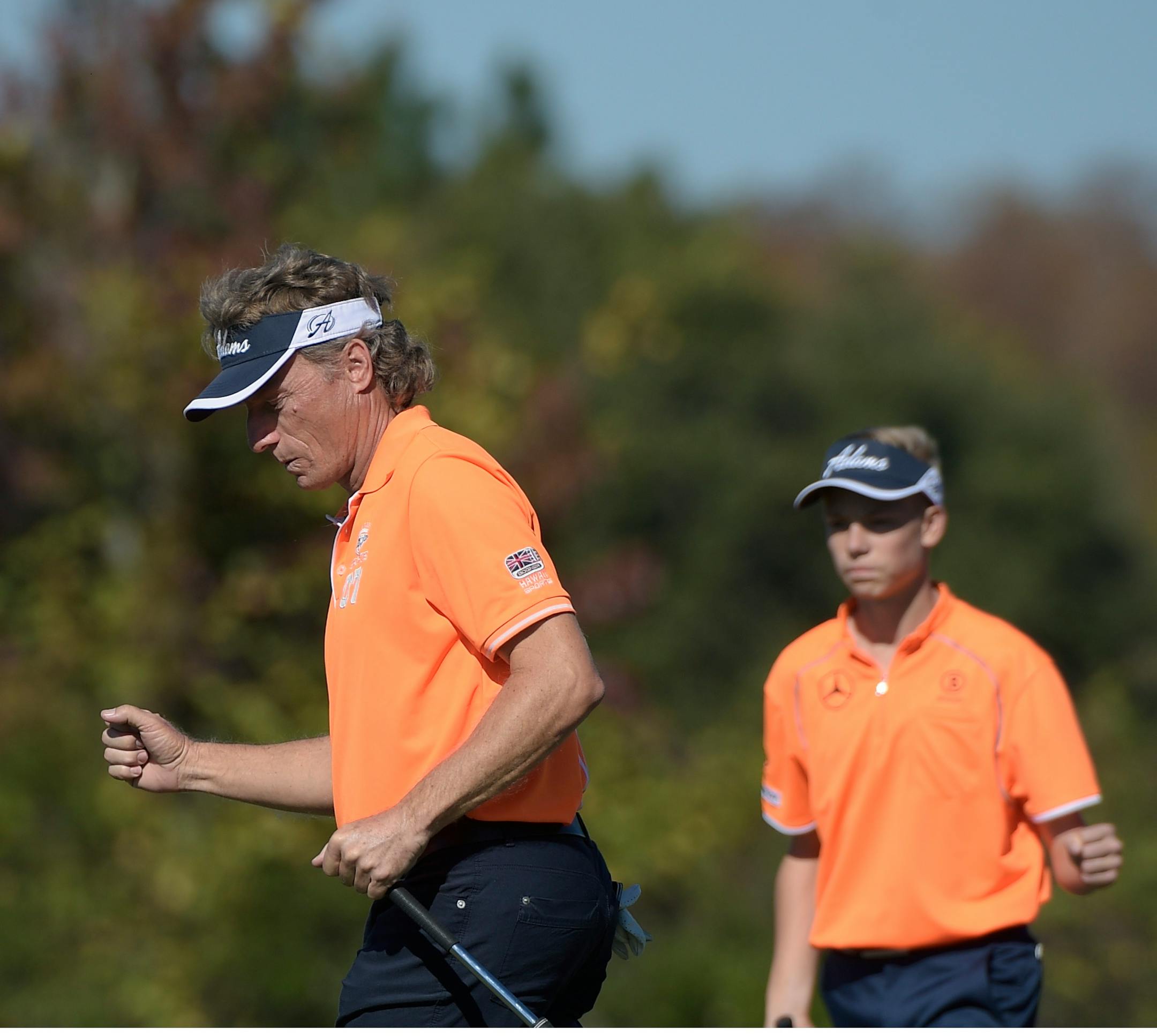 Bernhard Langer, left, and his son Jason Langer pump their fists after the elder Langer made his putt on the 12th green during the first round of the Father/Son Challenge golf tournament in Orlando, Fla., Saturday, Dec. 13, 2014.(AP Photo/Phelan M. Ebenhack)