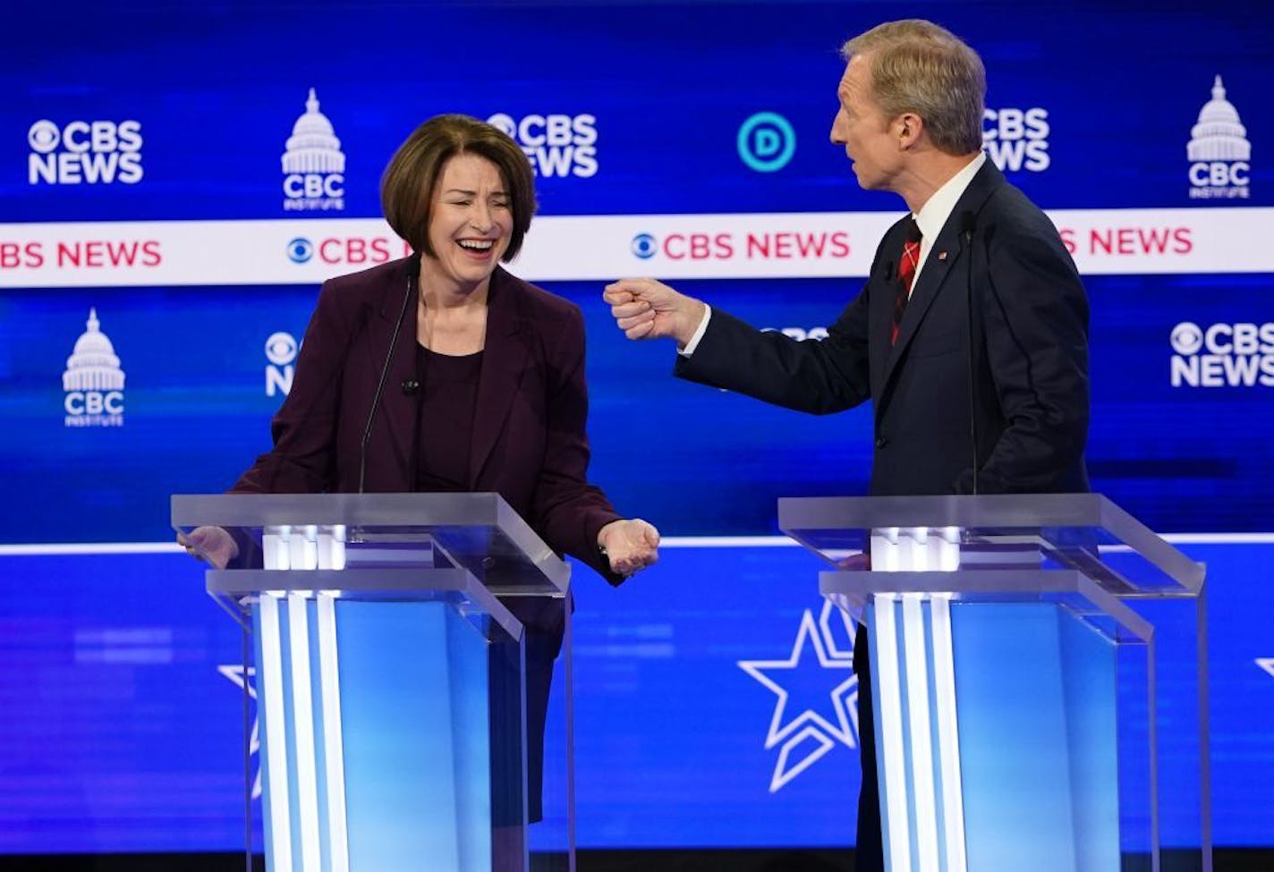 Sen. Amy Klobuchar (D-Minn.) reacts as Tom Steyer speaks during the Democratic presidential debate at the Gaillard Center in Charleston, S.C., Feb. 25, 2020.