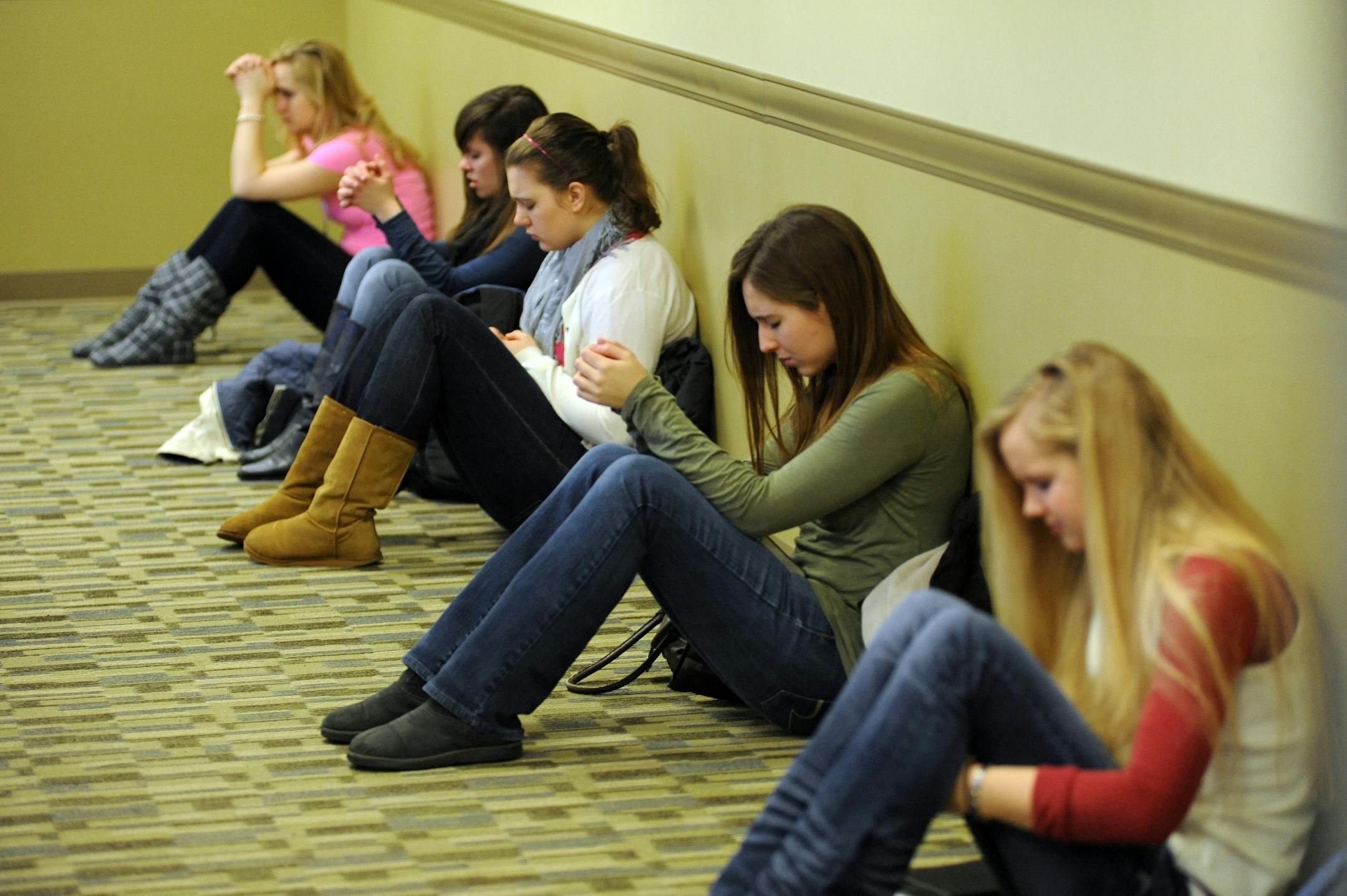 Some of the students who attended a prayer session Wednesday morning at the North Dakota State University student union sat along a wall as they prayed. The prayer service for the families of four students killed in a car crash was organized by the Chi Alpha Christian Fellowship, a student Christian group on campus..