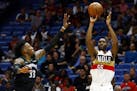 New Orleans Pelicans guard E'Twaun Moore (55) shoots as Minnesota Timberwolves forward Robert Covington (33) tries to defend during the second half of