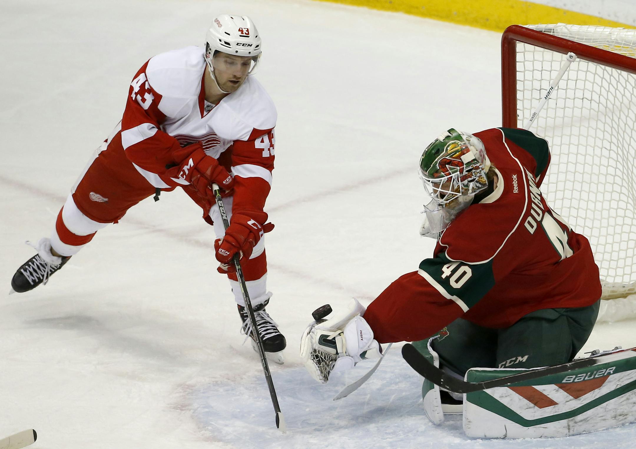 Wild goalie Devan Dubnyk scooped up a shot by Red Wings center Darren Helm (43) during the first period Monday night.